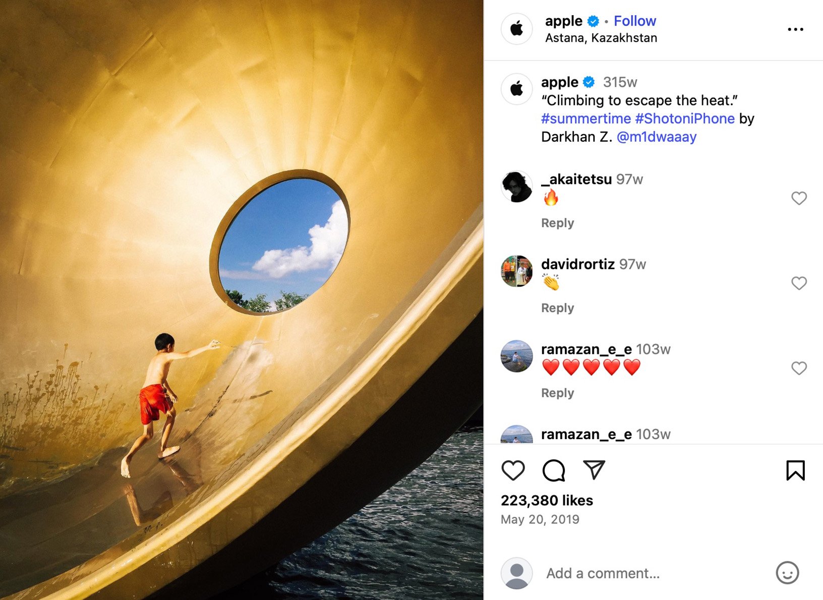 Apple shares #ShotoniPhone summer capture by Darkhan Z in Kazakhstan Boy climbing inside large gold sculpture with circular sky window, Astana Kazakhstan
