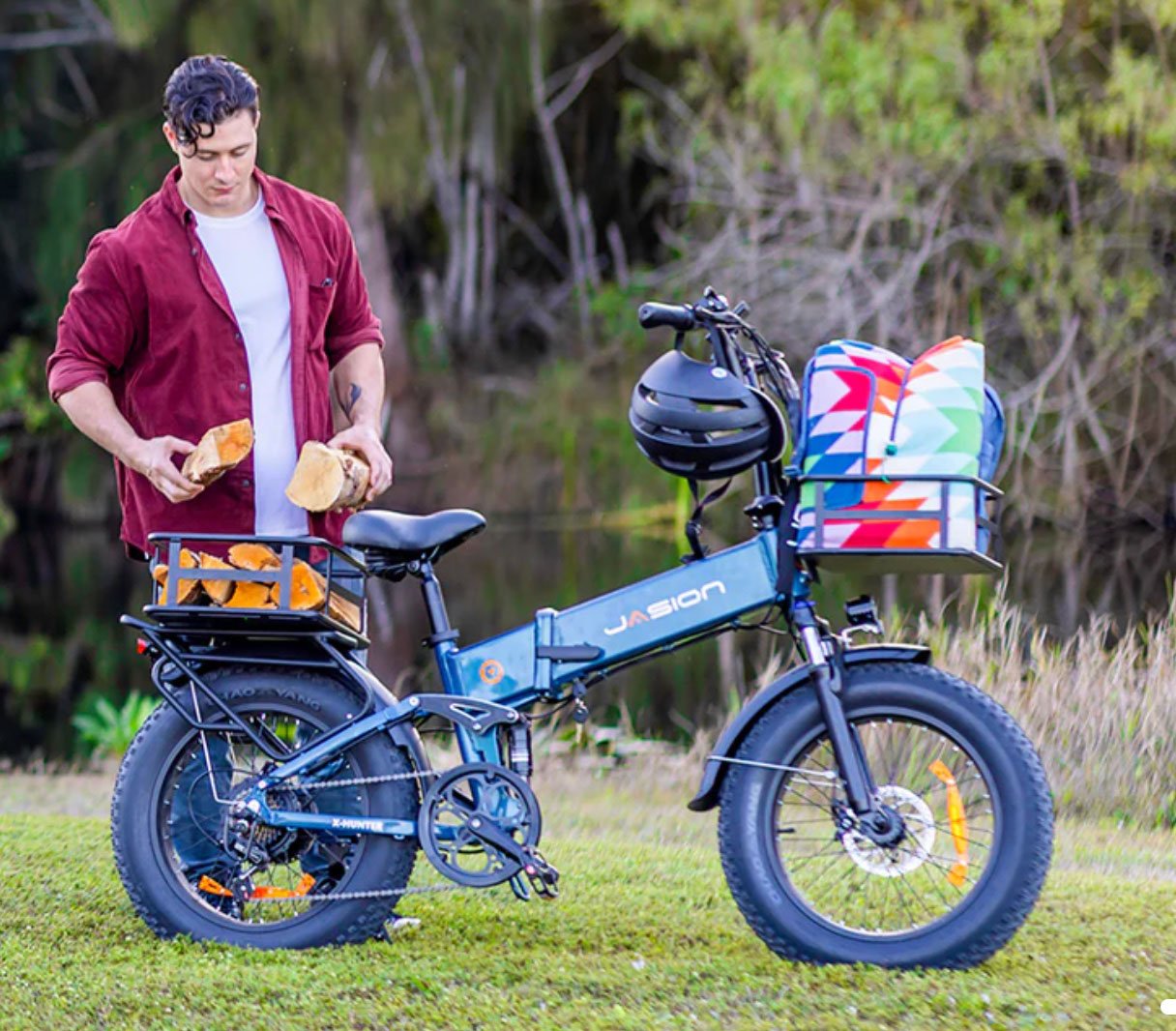 Man loading firewood into rear cargo rack of a Jasion electric bike parked on grass
