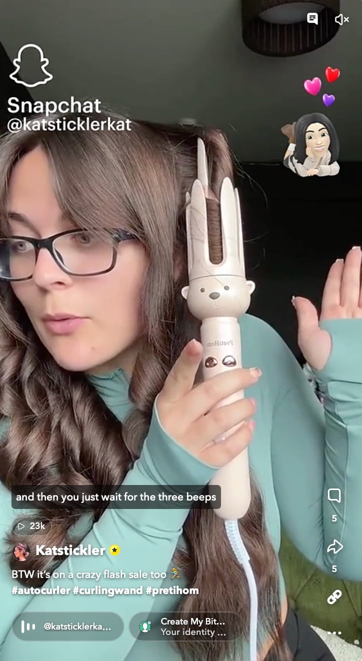 Snapchat creator demonstrating how to use a bear-themed automatic curling wand