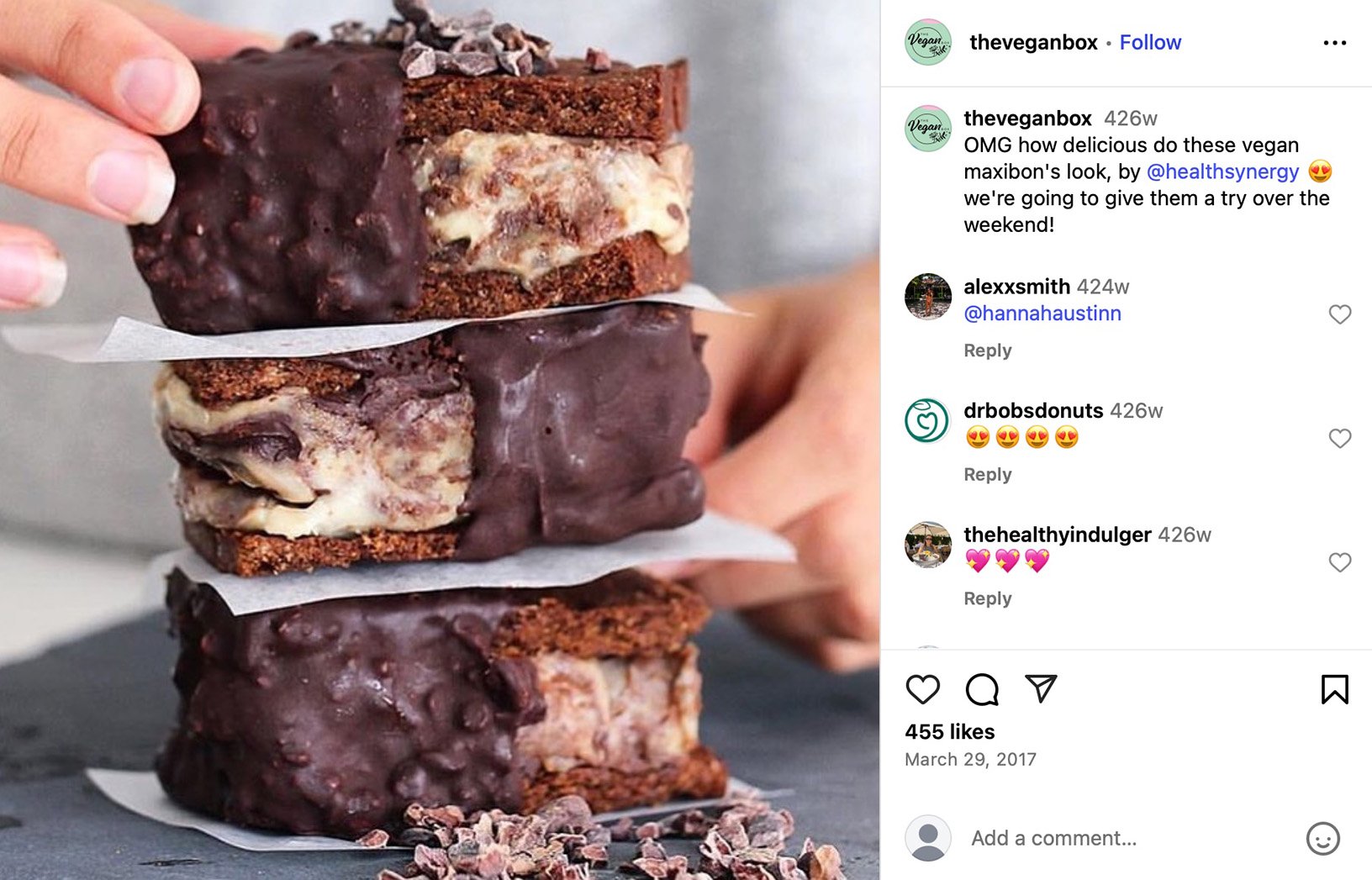 The Vegan Box features delicious plant-based maxibons by @healthsynergy Three stacked vegan ice cream cookie sandwiches covered in chocolate