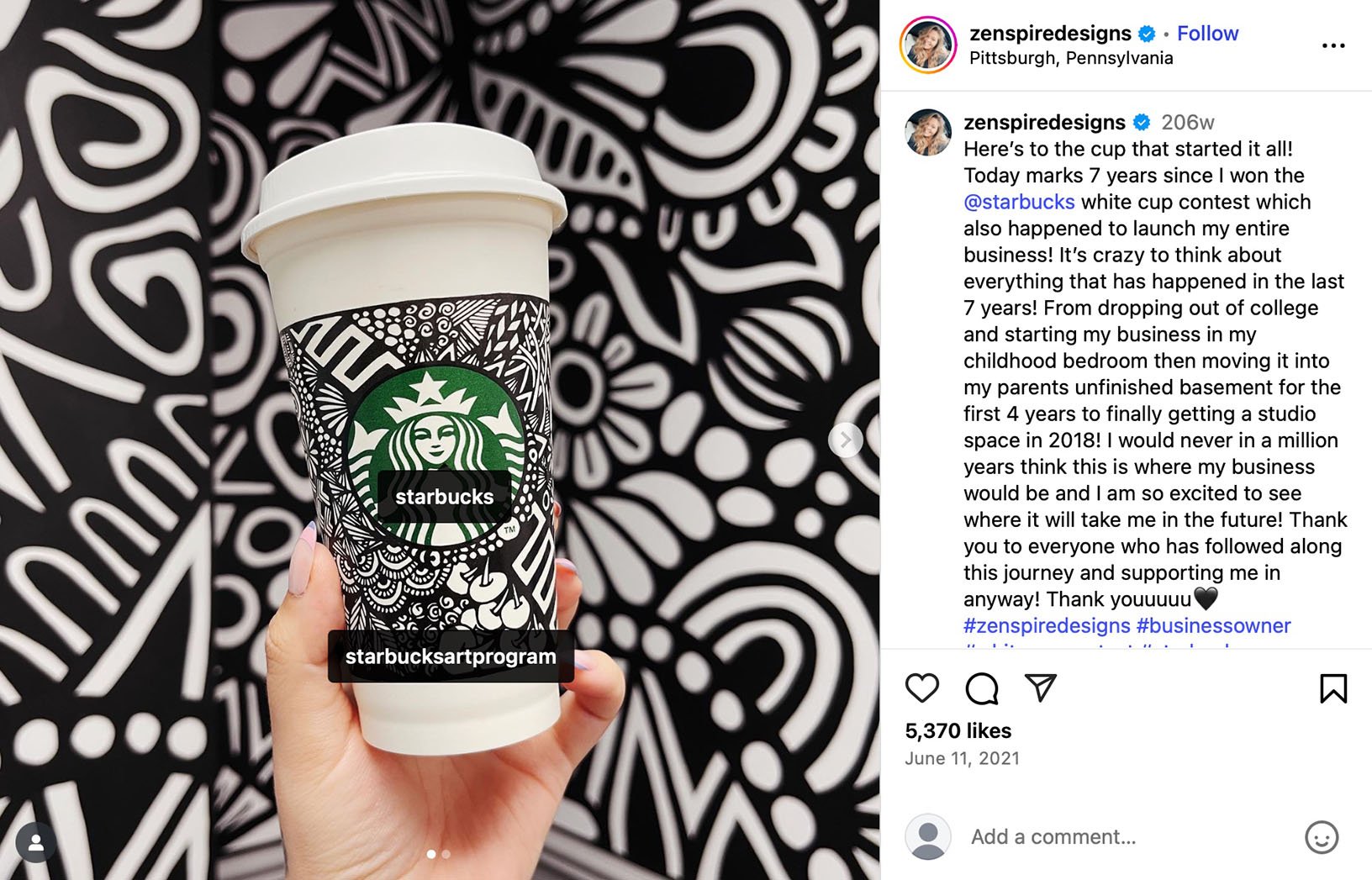 Starbucks White Cup Contest winner celebrates 7 years of creative success Hand holding a Starbucks cup decorated with intricate black-and-white line art, with a matching patterned backdrop